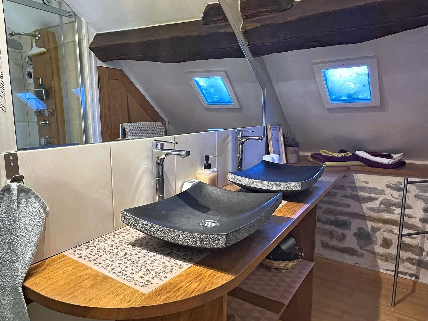The stone basin in the En Messepierre bathroom, under the eaves