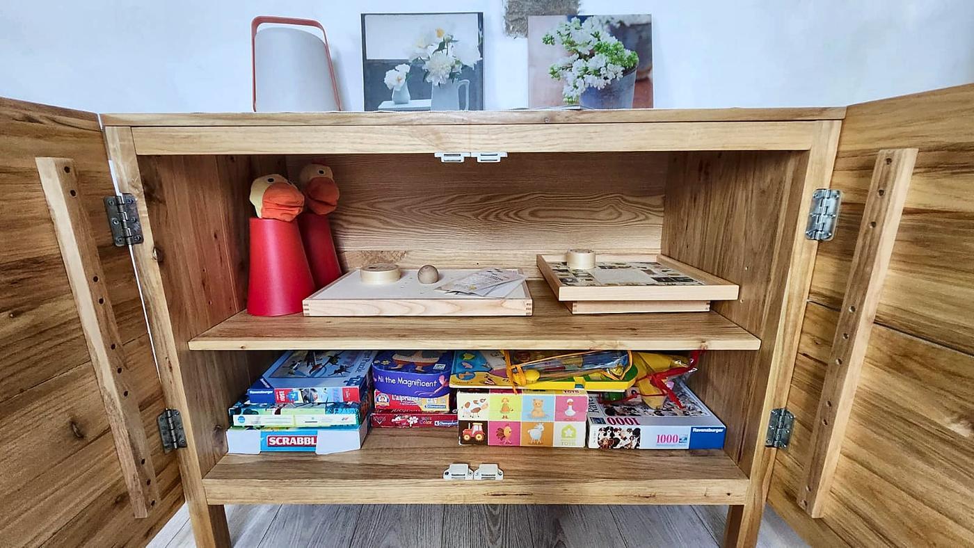 The open sideboard in Les Terrasses, with its board games and toys