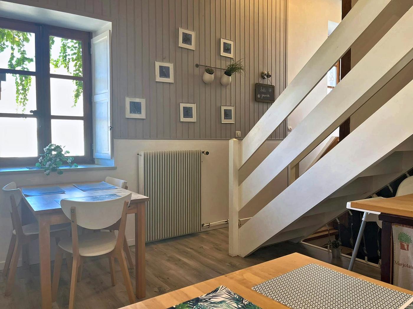 The half-landing, its pale wooden staircase and dining corner