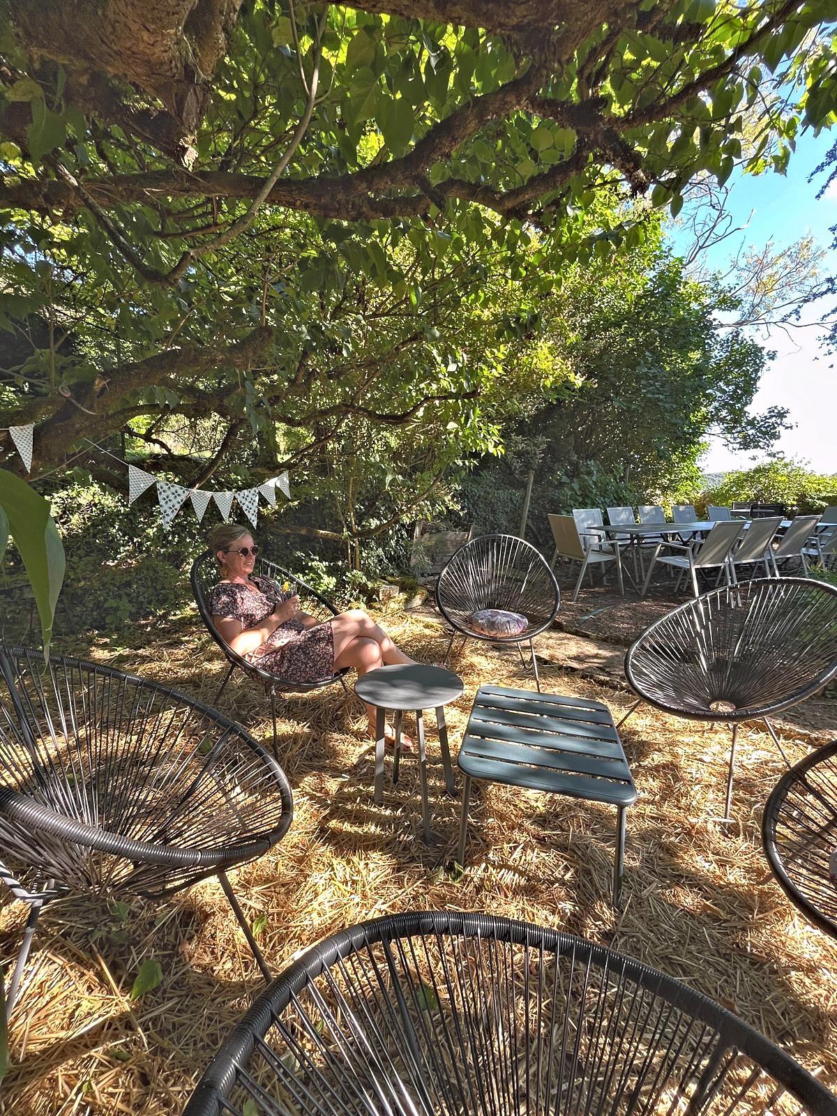 The garden table under the trees, with string lights and bunting