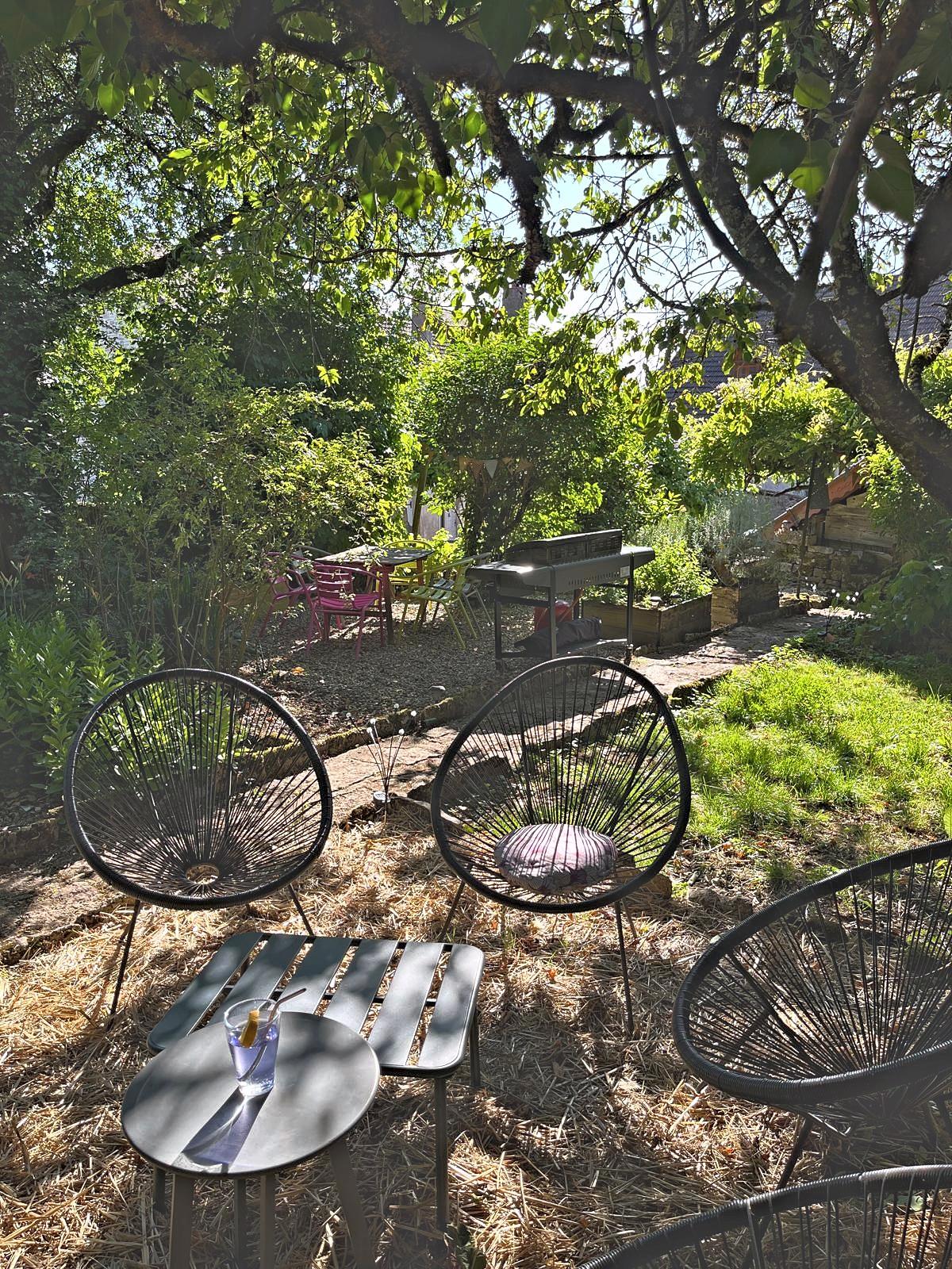 The table and seating in the shade, at the bottom of the garden