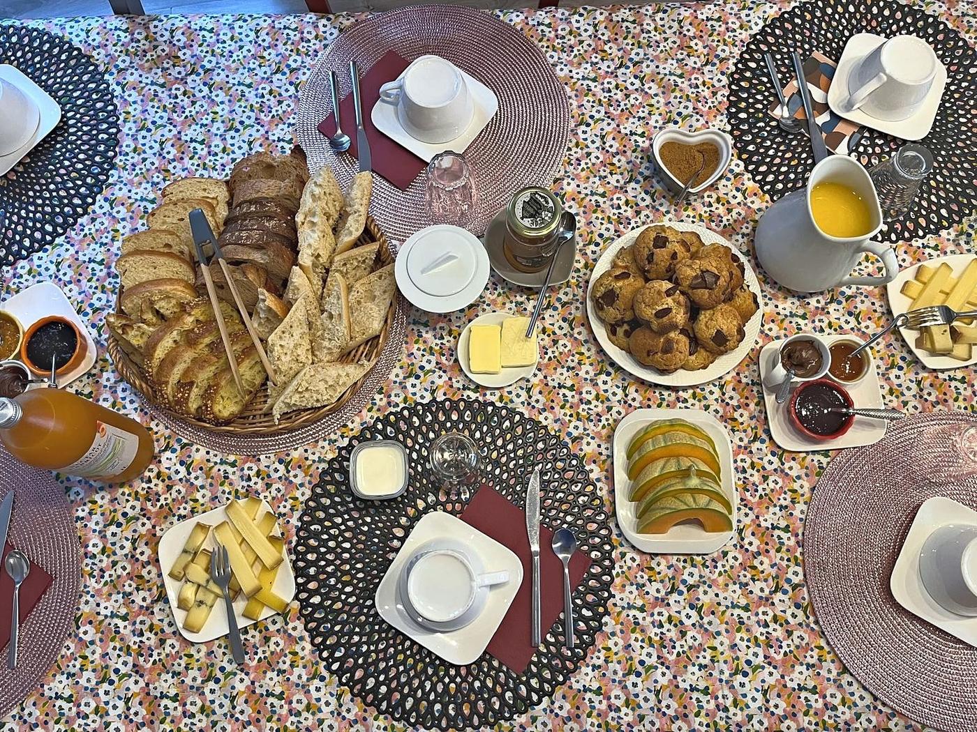 The breakfast table: pastries, jams and fresh fruit