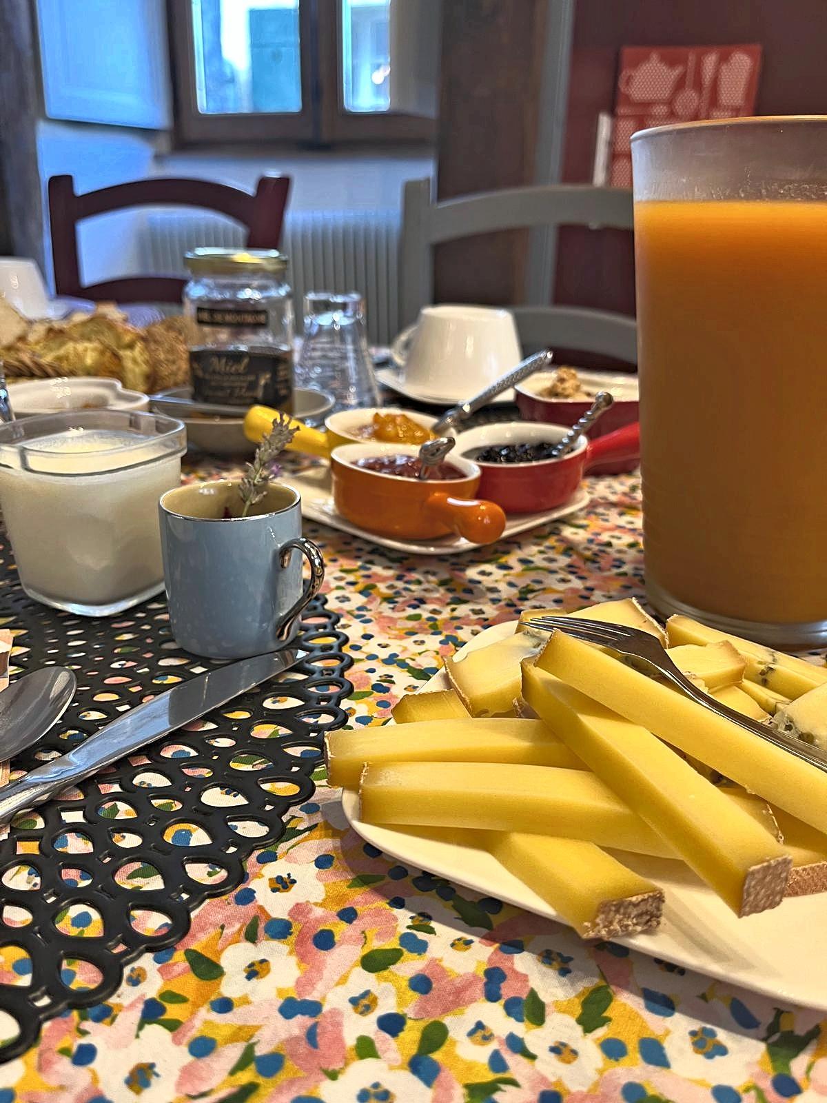 Orange juice, home-made jams and a basket of bread